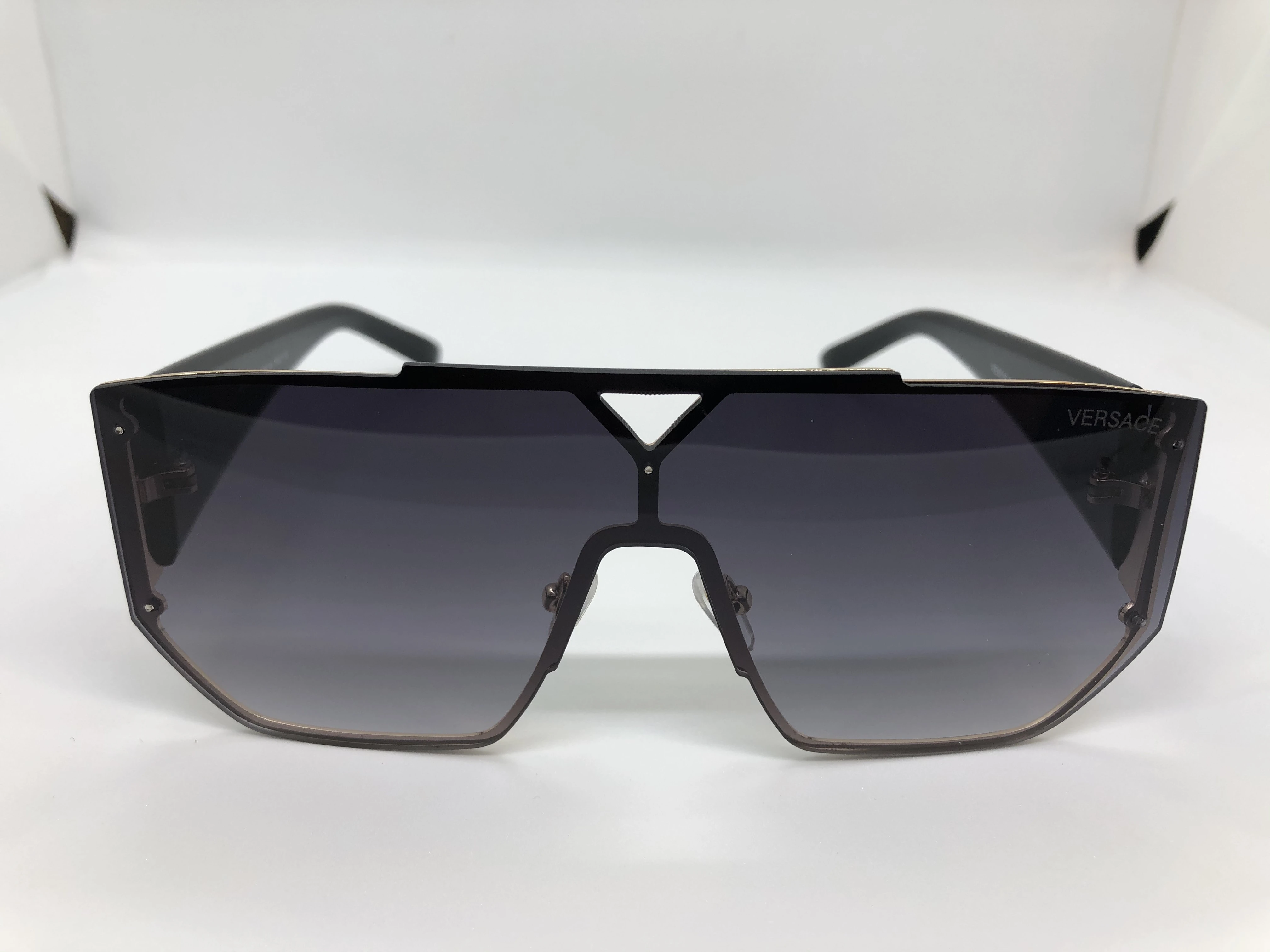 Sunglasses - from Versace - with a golden metal frame - black gradient lenses - and a black polycarbonate arm - with a gold * black logo