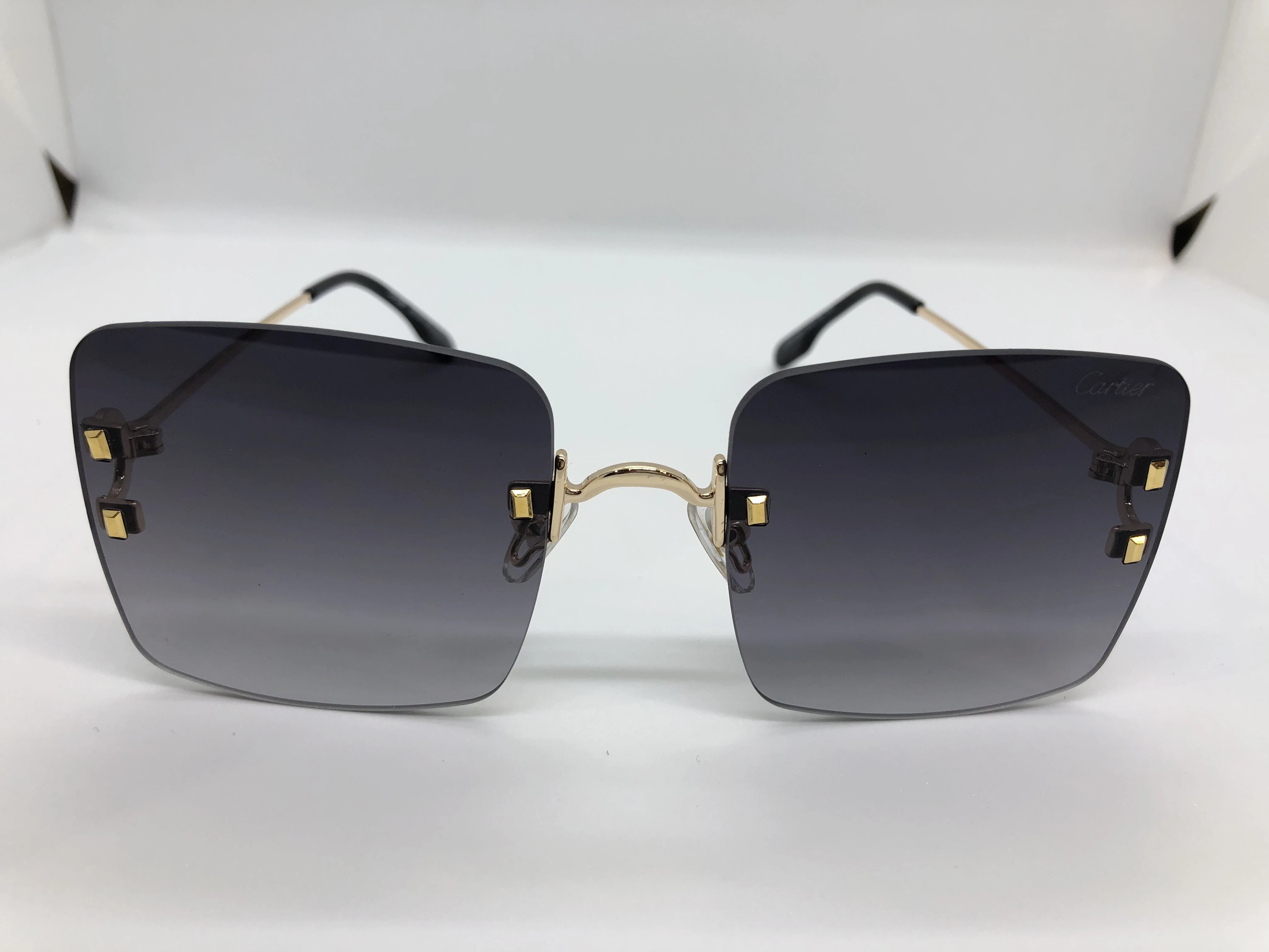 Cartier sunglasses - without frame - black gradient lenses - and golden metal arm - for women